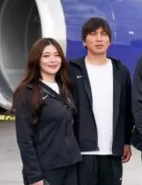 水原一平が飛行機の前で妻と並んでいる様子。血液型に関心が集まる中で、笑顔が印象的な一枚。